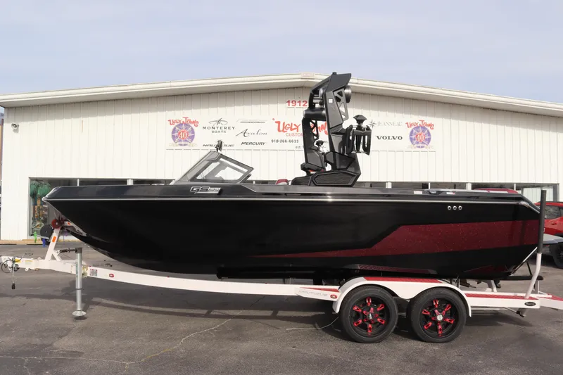 Slide: The Image of 2024 Nautique GS22 boat on a trailer outside a dealership. - 3