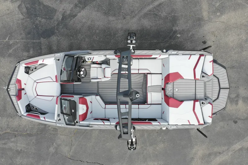 Slide: The Image of 2024 Nautique GS22 boat interior, top view, white and red upholstery, sleek design. - 6