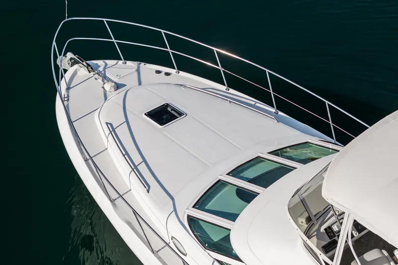 Slide: The Image of 1997 Sea Ray 420 Aft Cabin yacht on calm water. - 11