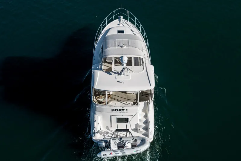 Slide: The Image of Aerial view of a 1997 Sea Ray 420 Aft Cabin yacht cruising on water. - 12