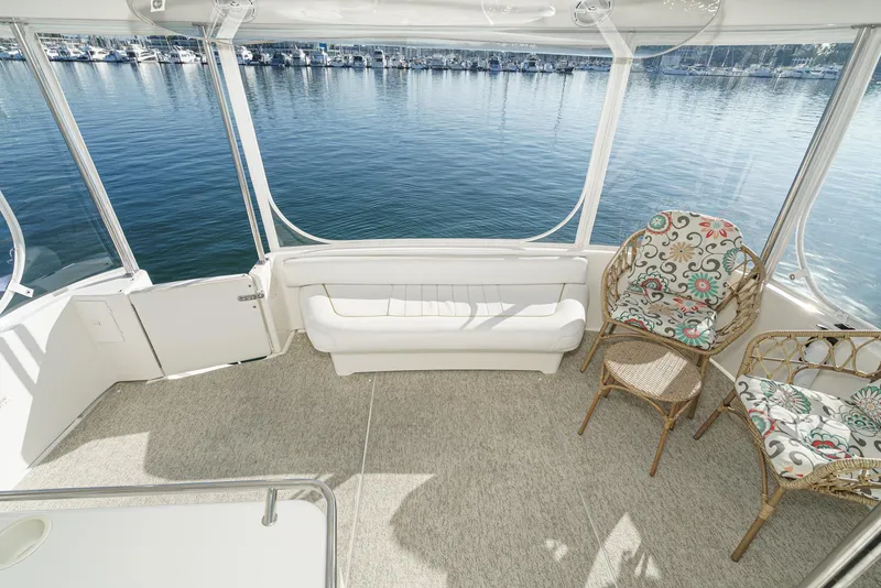 Slide: The Image of 1997 Sea Ray 420 Aft Cabin interior with seating and waterfront view. - 16