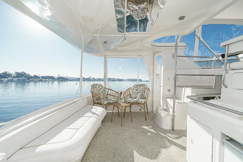 Slide: The Image of 1997 Sea Ray 420 Aft Cabin interior with waterfront view and seating area. - 18