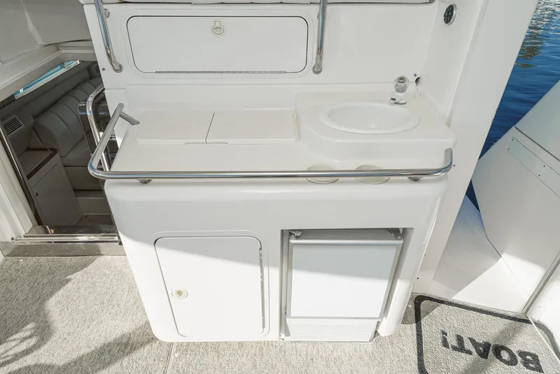 Slide: The Image of 1997 Sea Ray 420 Aft Cabin yacht kitchenette with sink and storage. - 21