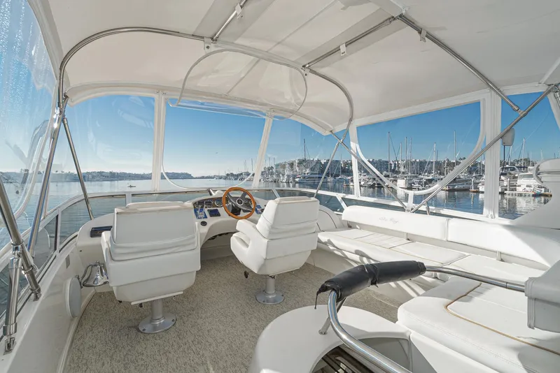 Slide: The Image of 1997 Sea Ray 420 Aft Cabin yacht interior with helm and seating area. - 22