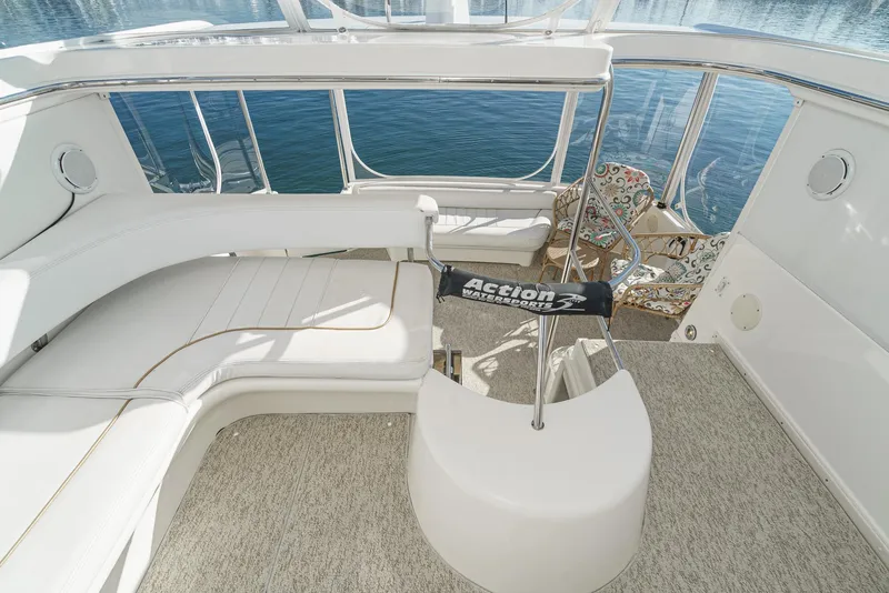 Slide: The Image of 1997 Sea Ray 420 Aft Cabin yacht interior with white seating and lake view. - 23