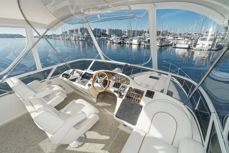 Slide: The Image of 1997 Sea Ray 420 Aft Cabin yacht helm with marina view. - 25