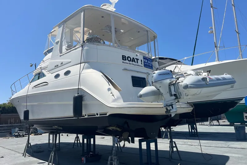 Slide: The Image of 1997 Sea Ray 420 Aft Cabin yacht on stands, with attached Honda motorboat. - 75