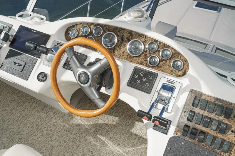 Slide: The Image of 1997 Sea Ray 420 Aft Cabin helm with wood steering wheel and instrument panel. - 30
