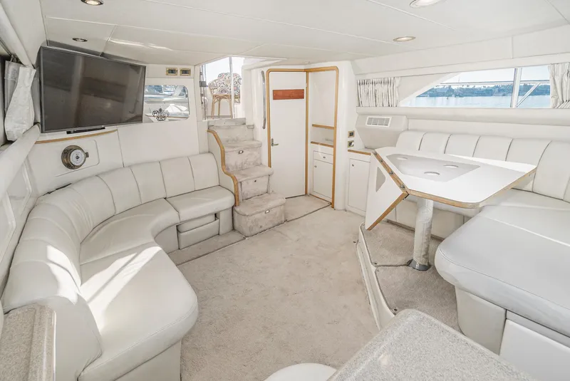 Slide: The Image of 1997 Sea Ray 420 Aft Cabin interior with white leather seating and modern amenities. - 39