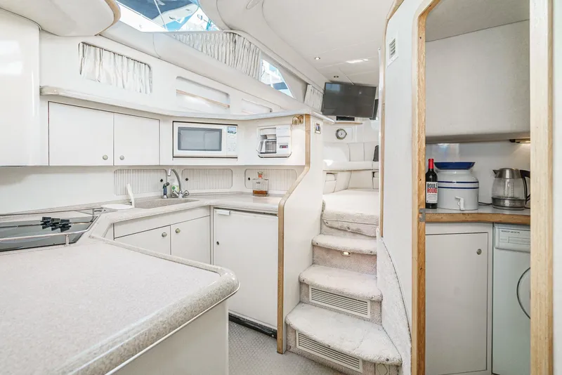 Slide: The Image of 1997 Sea Ray 420 Aft Cabin yacht interior kitchen and stairs. - 42