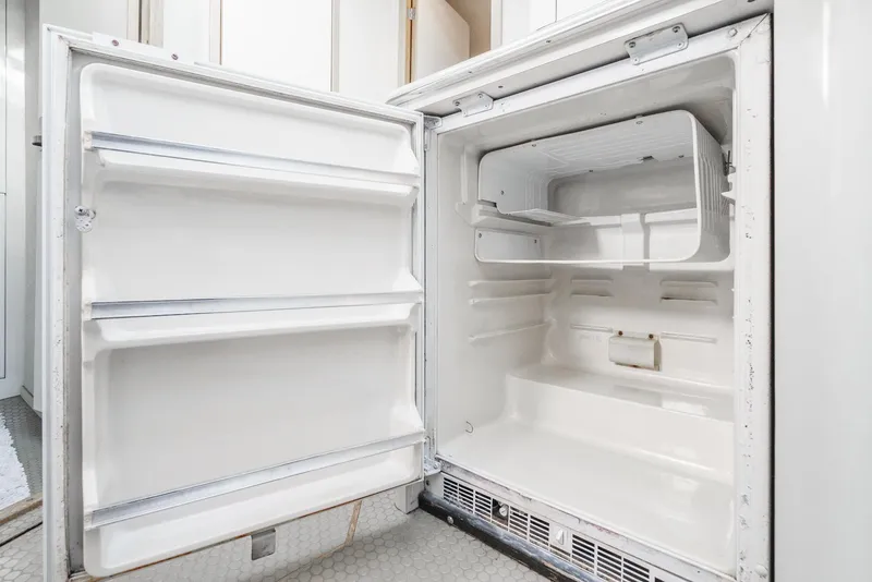 Slide: The Image of 1997 Sea Ray 420 Aft Cabin refrigerator interior, open and empty. - 43