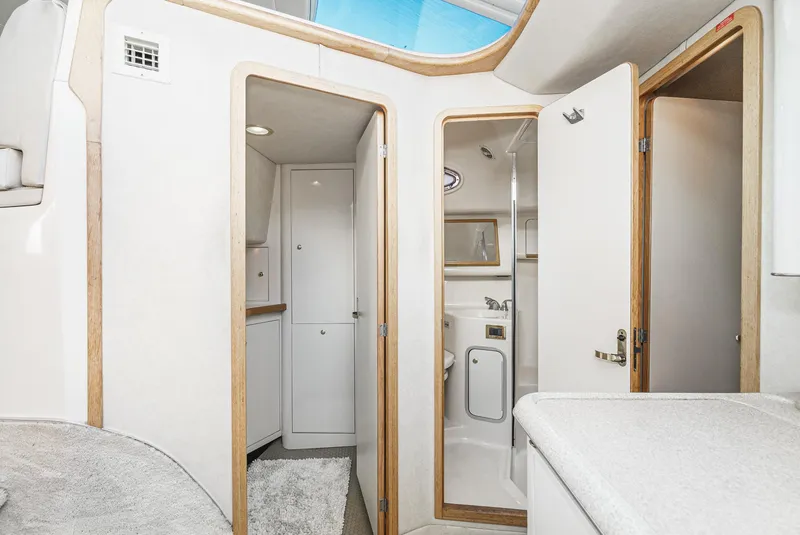 Slide: The Image of 1997 Sea Ray 420 Aft Cabin interior with bathroom and storage compartments. - 44