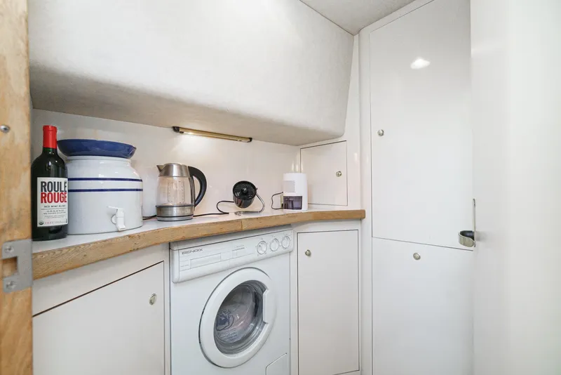 Slide: The Image of Laundry area in 1997 Sea Ray 420 Aft Cabin yacht with washer and countertop appliances. - 45