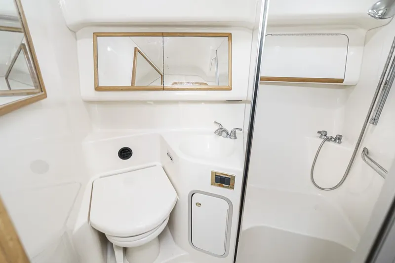 Slide: The Image of 1997 Sea Ray 420 Aft Cabin bathroom with shower, sink, and toilet. - 46