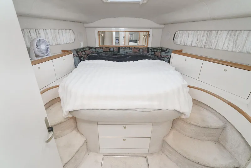 Slide: The Image of Luxurious 1997 Sea Ray 420 Aft Cabin bedroom with cozy bed and ample storage. - 5