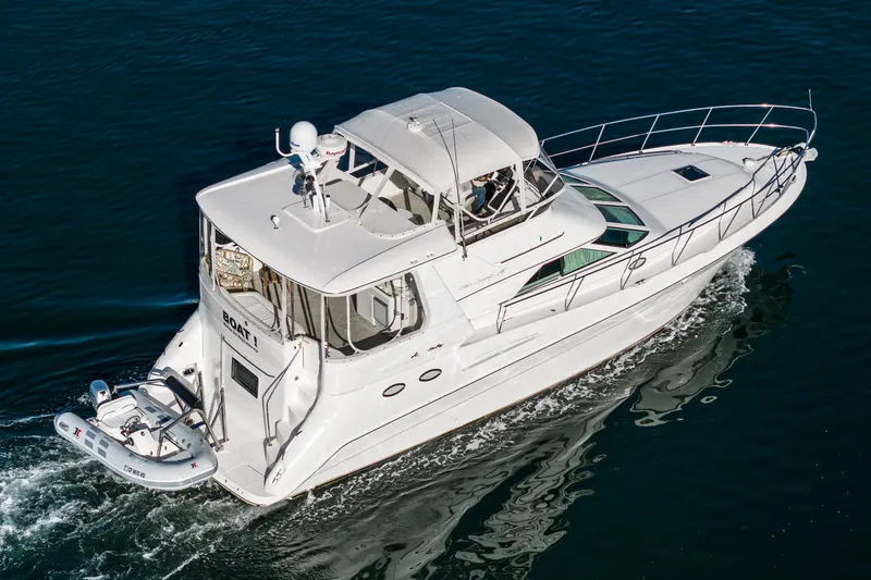 Slide: The Image of 1997 Sea Ray 420 Aft Cabin yacht cruising on open water. - 9