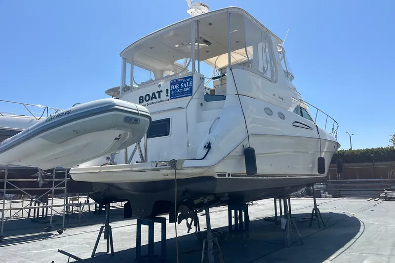 Slide: The Image of 1997 Sea Ray 420 Aft Cabin yacht on stands, for sale, sunny day. - 74