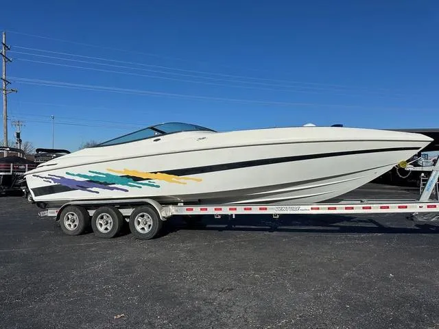 Slide: The Image of 1997 Baja Boss 302 speedboat on a trailer with colorful graphics. - 1
