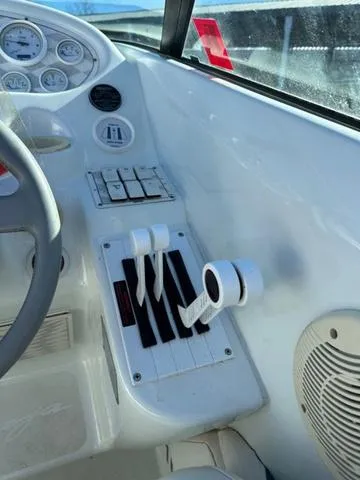 Slide: The Image of 1997 Baja Boss 302 speedboat with white and colorful interior, docked at marina. - 11