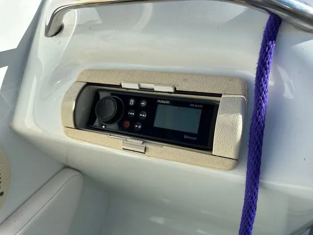 Slide: The Image of 1997 Baja Boss 302 boat cockpit with white and multicolored seat. - 13