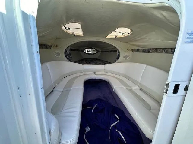 Slide: The Image of 1997 Baja Boss 302 boat interior with white and multicolored seats. - 16