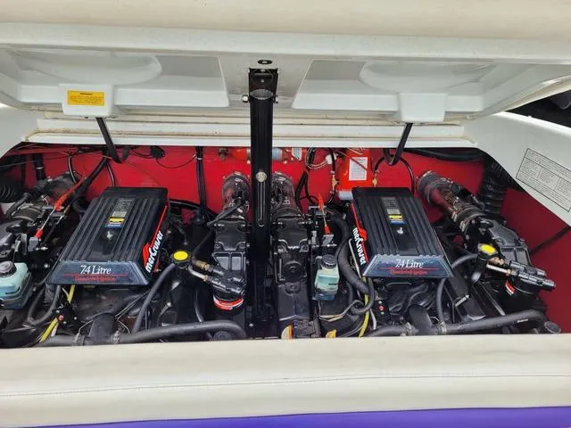 Slide: The Image of 1997 Baja Boss 302 boat interior with colorful seating and white upholstery. - 18