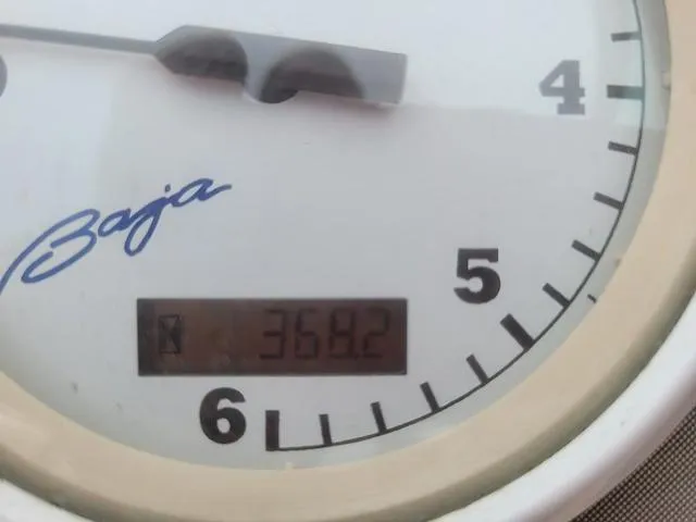 Slide: The Image of 1997 Baja Boss 302 boat cabin interior with bed and seating. - 19