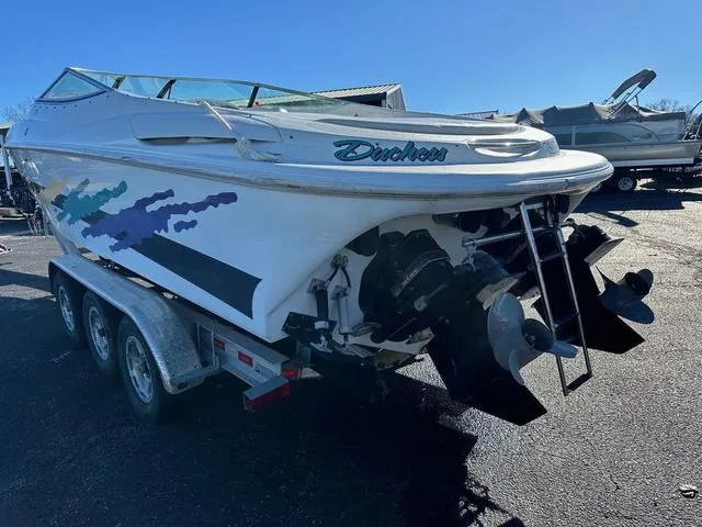 Slide: The Image of Close-up of a 1997 Baja Boss 302 boat with visible scratches and scuffs. - 4