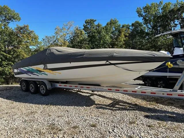 Slide: The Image of 1997 Baja Boss 302 boat named Duchess on a trailer in a marina. - 6