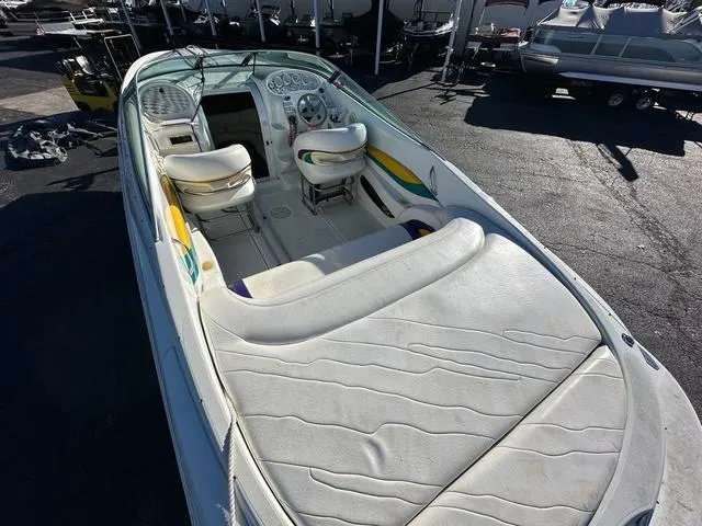 Slide: The Image of Close-up of a 1997 Baja Boss 302 boat with colorful wave graphics. - 7