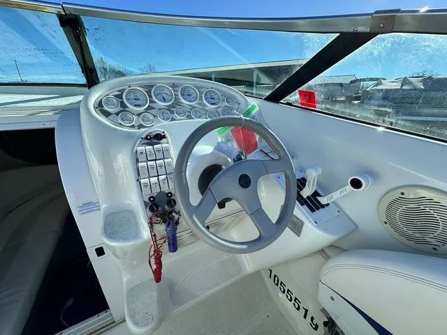 Slide: The Image of 1997 Baja Boss 302 speedboat on a trailer under a clear blue sky. - 8