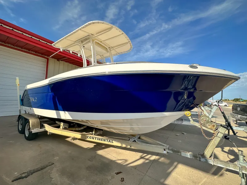 Slide: The Image of 2017 Robalo R222 boat on a Continental trailer, blue hull, parked outdoors. - 13