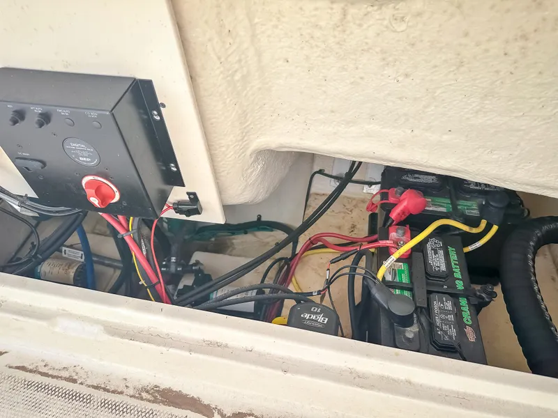 Slide: The Image of 2017 Robalo R222 boat battery compartment with wiring and electrical components. - 9