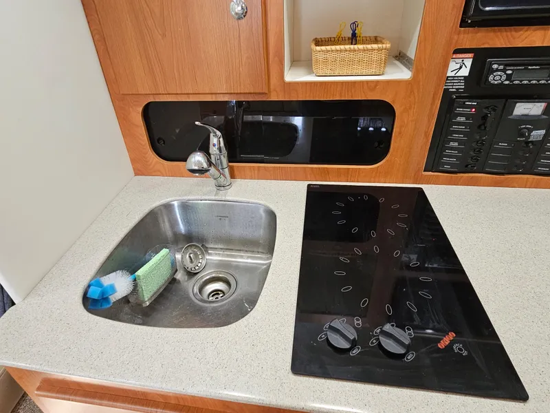 Slide: The Image of 2006 Bayliner 325 yacht kitchen with sink and stovetop. - 10