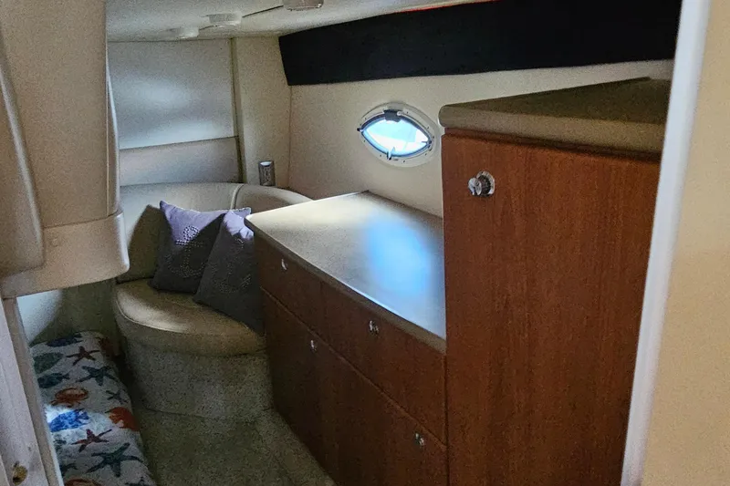 Slide: The Image of Interior cabin of a 2006 Bayliner 325 boat with seating and storage. - 11