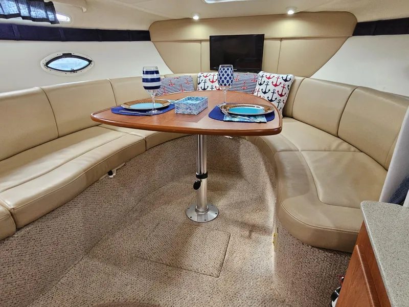 Slide: The Image of Luxurious interior of 2006 Bayliner 325 yacht with cozy seating and dining area. - 8