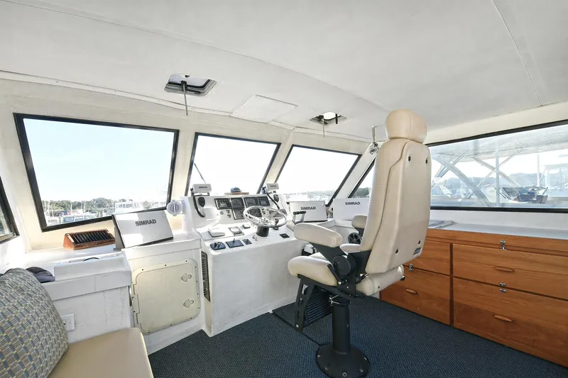 Slide: The Image of Interior of 2000 Torres 48 Enclosed Bridge yacht with captain's chair and navigation equipment. - 10