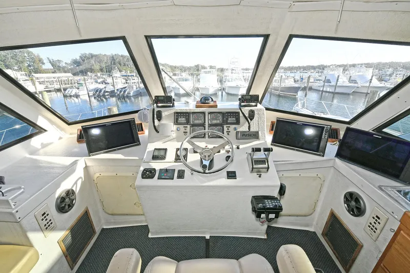 Slide: The Image of Cockpit of 2000 Torres 48 Enclosed Bridge yacht with navigation equipment and panoramic windows. - 11