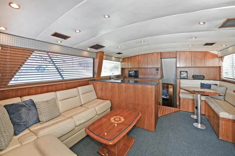 Slide: The Image of Luxurious interior of 2000 Torres 48 Enclosed Bridge yacht with modern furnishings and wood accents. - 17