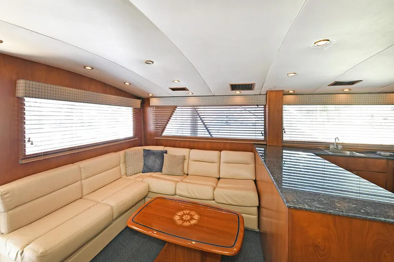 Slide: The Image of Luxurious interior of 2000 Torres 48 Enclosed Bridge yacht with leather seating and wooden accents. - 18