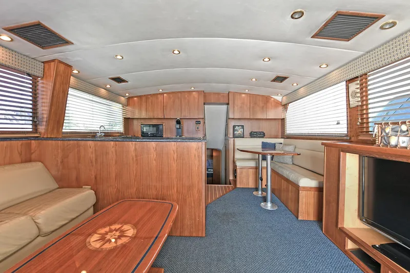 Slide: The Image of Luxurious interior of 2000 Torres 48 Enclosed Bridge yacht with wood finishes and modern amenities. - 20