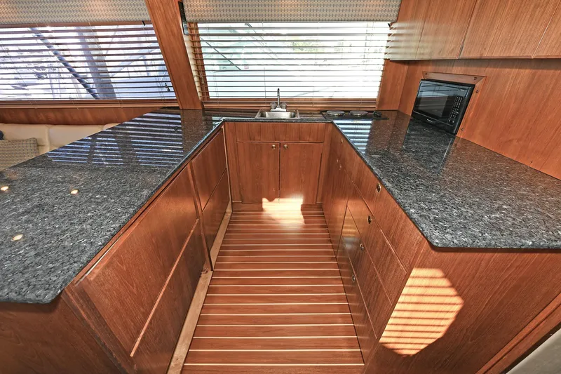 Slide: The Image of Luxurious kitchen interior of 2000 Torres 48 Enclosed Bridge yacht with granite countertops. - 26