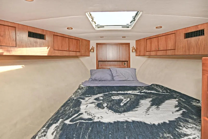 Slide: The Image of Interior cabin of 2000 Torres 48 Enclosed Bridge with bed and wooden cabinets. - 27