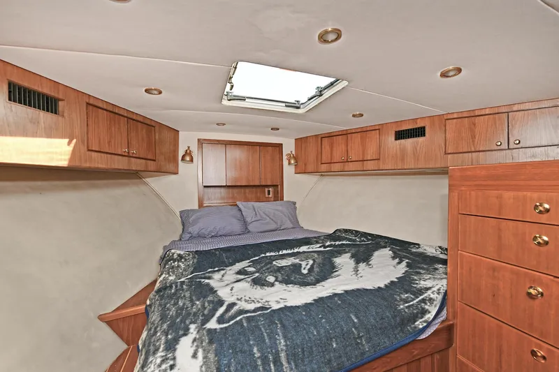 Slide: The Image of Luxurious cabin interior of 2000 Torres 48 Enclosed Bridge yacht with wood cabinetry. - 28