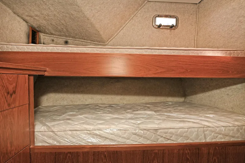 Slide: The Image of Bunk beds in 2000 Torres 48 Enclosed Bridge yacht cabin, featuring wood finish and compact design. - 29