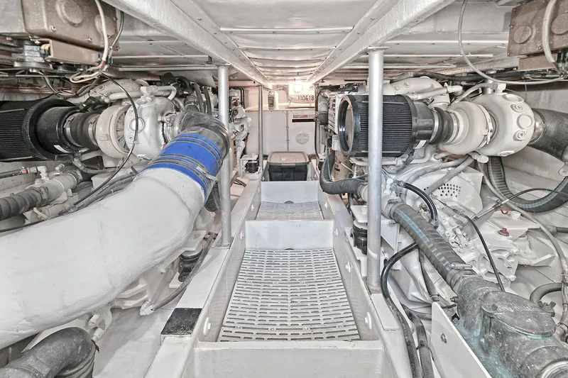 Slide: The Image of Engine room of 2000 Torres 48 Enclosed Bridge yacht, showcasing dual engines and mechanical components. - 32