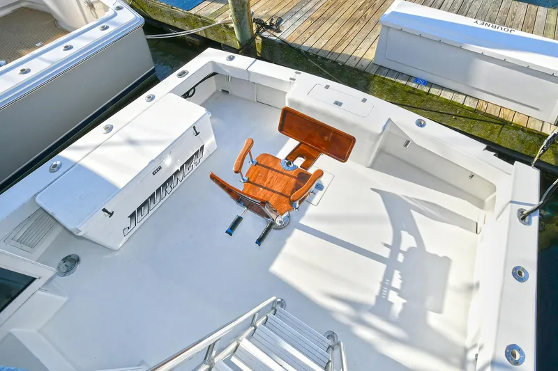 Slide: The Image of Torres 48 Enclosed Bridge 2000 boat deck with fishing chair and storage compartments. - 4