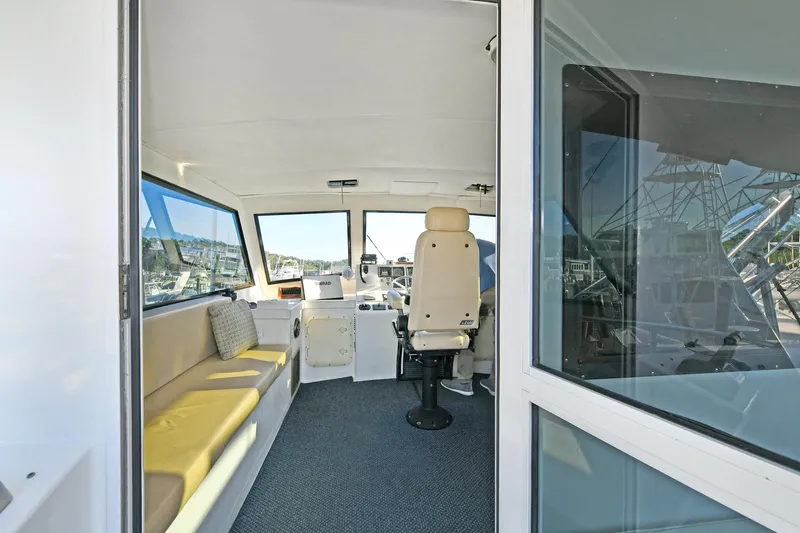 Slide: The Image of Interior of 2000 Torres 48 Enclosed Bridge boat with seating and helm. - 6