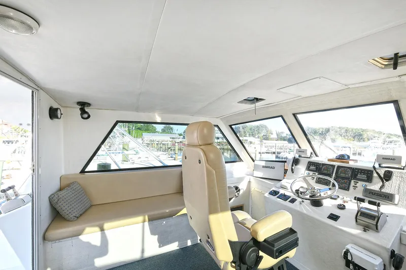 Slide: The Image of Interior of 2000 Torres 48 Enclosed Bridge yacht with helm and seating area. - 8