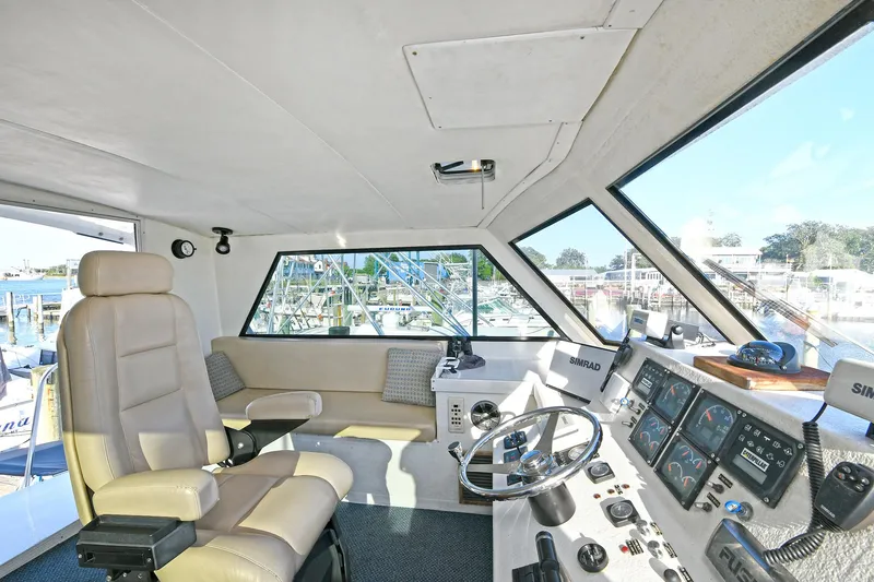 Slide: The Image of Interior of 2000 Torres 48 Enclosed Bridge yacht with helm and seating area. - 9